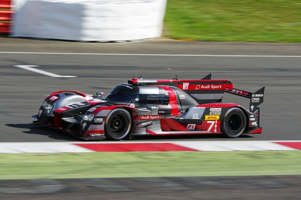 gray and red car on roadway during day time